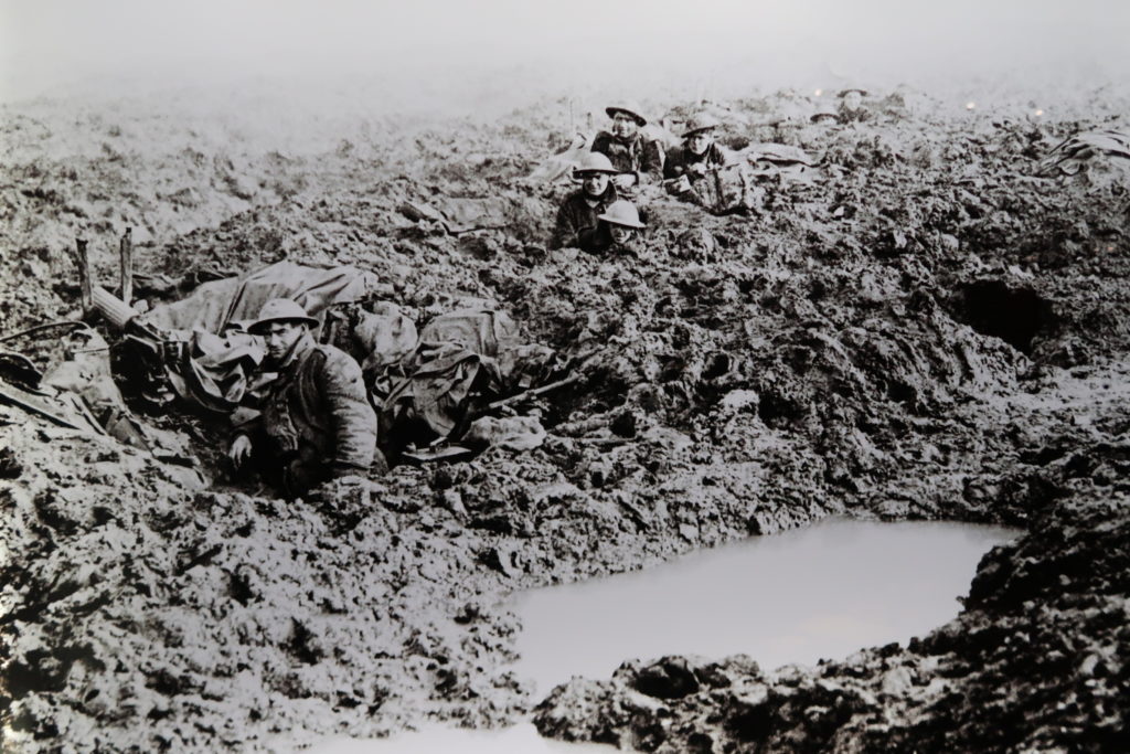 Soldiers amidst the mud and water-filled craters of Passchendaele. The waterfields are now pasture land for cattle below the ridge that was captured November 10, 1917.