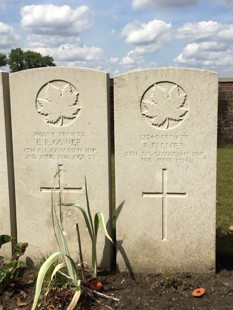 Two Commonwealth War Graves Commission headstones for Ptivates E.F. Gower and Roy Palmer, late of the 8th Canadian Infantry Battalion "The Little Black Devils". The markers are inscribed with a maple leaf representative of Canada and a Christian cross. The markers  are identical in style.