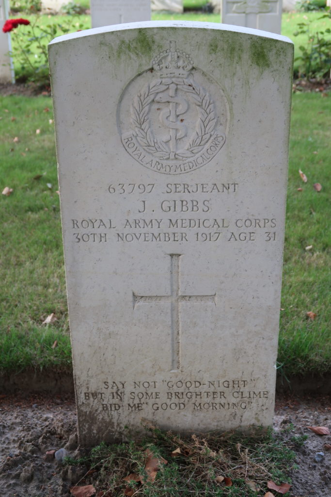 The full length headstone of Sergeant J. Gibbs includes the insignia of the Royal Army Medical Corps, a Cadeuscus, (a snake wrapped aroundd a pole). Contained within a wreath with the King's Crown above.