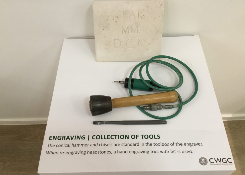 Conical hammer and chisels sit on a plinth at the Commonwealth War Graves Commission Visitor's Centre. An example of their engraving is shown  "BAR MM DCM" in reference to British honours.