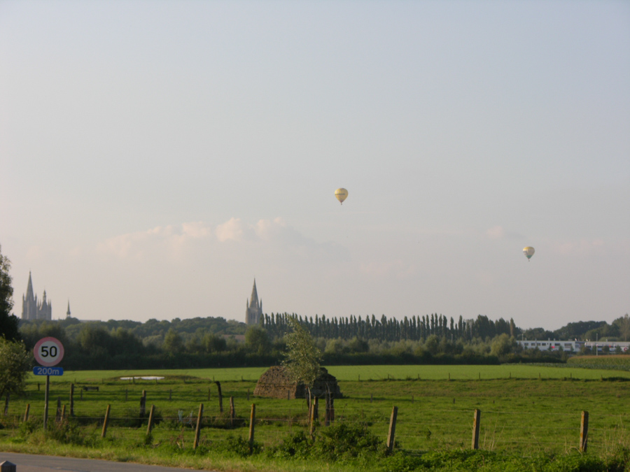 Hot air balloons over farmer's fields.